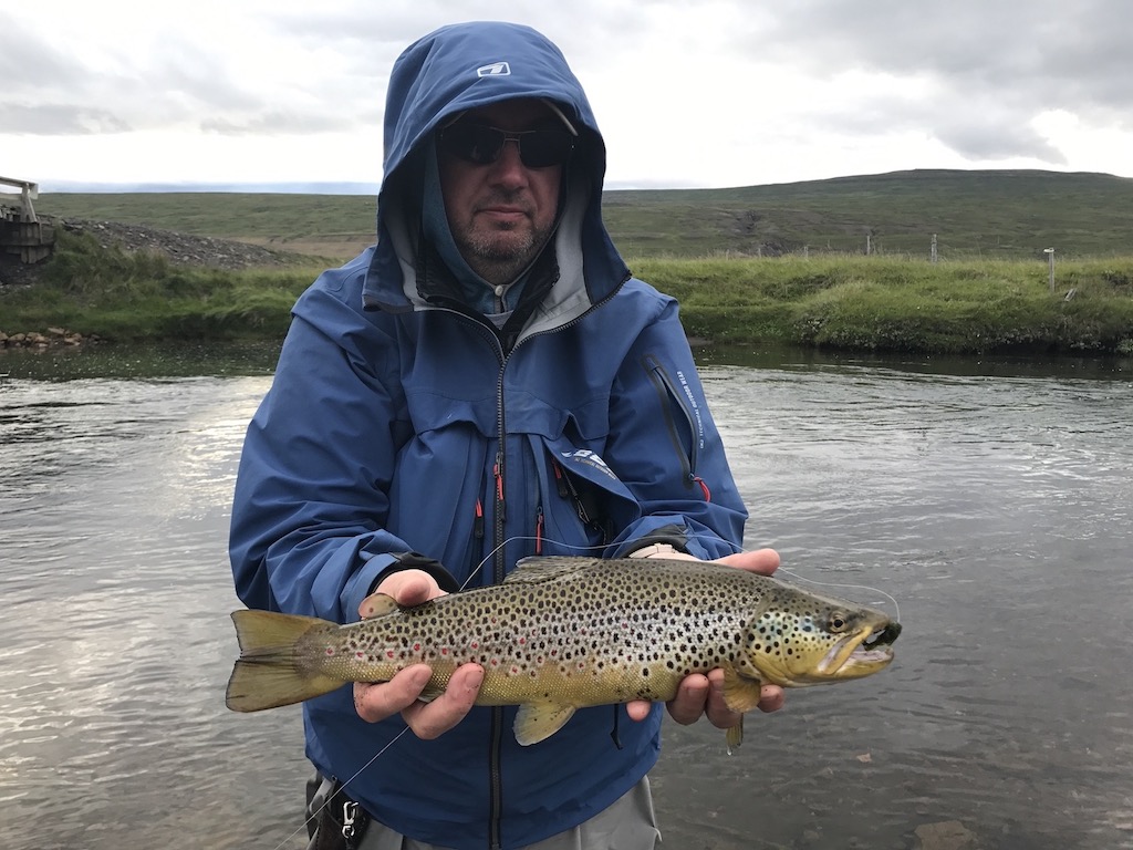 Man holding brown trout on the Vesturdalsa River